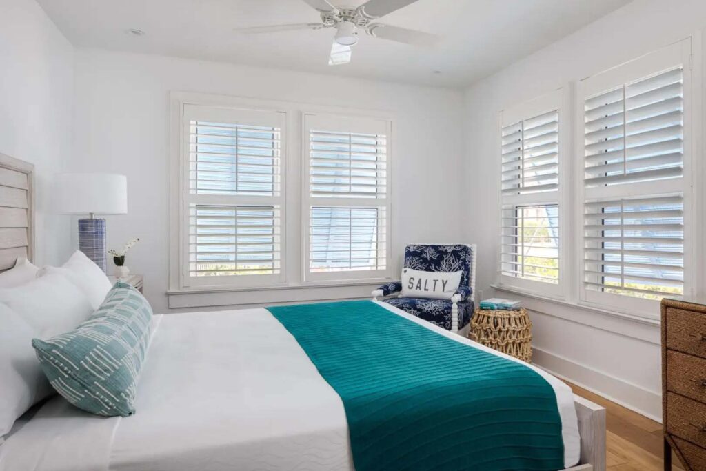 Coquina Cottage master bedroom with king bed and small sitting area at the Capri Inn