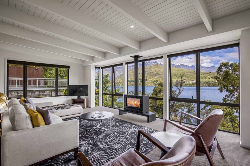 Rees Residence living room with fireplace and lake view